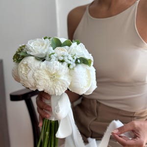 Charming bridal bouquet and boutonniere with white peonies and other flowers