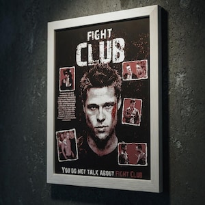 May include: Framed poster with the text "FIGHT CLUB" in white letters on a black background. The poster features a central image of a man's face, surrounded by smaller images and the phrase "YOU DO NOT TALK ABOUT FIGHT CLUB".