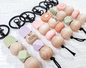 Keychain with rainbow or daisies, silicone beads and wooden balls, black nylon strap, black ring and carabiner