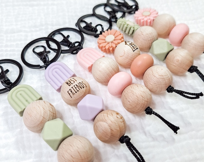 Keychain with rainbow or daisies, silicone beads and wooden balls, black nylon strap, black ring and carabiner