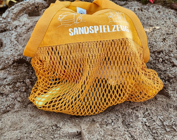 Sand-free beach and playground mesh bag for sand toys. Practical storage for children.