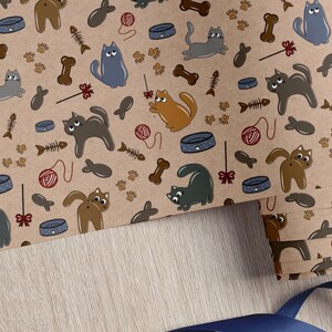 Purrfectly Playful Cats Wrapping Paper - Fun Cartoon Design with Paw Prints, Yarn and Toys on Brown Background - Ideal for Kids' Gifts