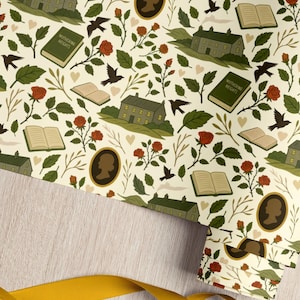 May include: Cream-coloured wrapping paper featuring a repeating pattern of green houses, open books, red roses, black birds, and cameo silhouettes. The book "Wuthering Heights" is visible. A yellow ribbon is in the foreground.