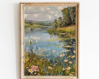May include: Framed landscape art print featuring a serene lake scene with colorful wildflowers and lush greenery. The artwork, titled "Printable art" by Blossom Print Gallery, is set against a cloudy sky, creating a tranquil and picturesque view.