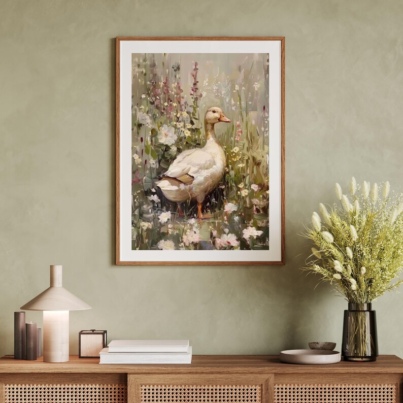 May include: A white duck standing in a field of flowers. The duck is facing to the right and has a long neck and a small head. The flowers are a variety of colors, including pink, purple, and white. The background is a soft green.
