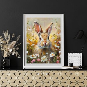 May include: A painting of a brown rabbit with white fur sitting in a field of white and pink flowers. The rabbit has long ears and a fluffy tail. The background is a soft yellow and green.