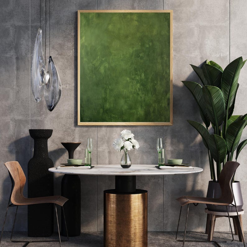 May include: A modern dining room setting featuring a round marble table with a gold base, surrounded by wooden chairs. A large green abstract painting hangs above the table. Decorative vases, glassware, and a potted plant complete the scene.