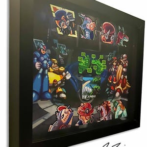 May include: A black shadow box frame containing a multi-layered 3D paper art display featuring pixelated characters from the Mega Man X video game series, including Mega Man X, various robotic enemies, and a central square panel labeled JUNGLE.