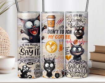 May include: Three stainless steel tumblers with black straws. Each tumbler features a different design with cartoon black cats and coffee-related phrases like "Don't Touch My Coffee" and "Sarcasm Served Daily."