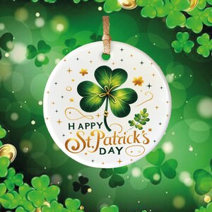 May include: White ceramic ornament with a green shamrock and gold lettering that reads "Happy St. Patrick's Day". The ornament is surrounded by green shamrocks.