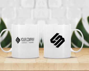 May include: Two white ceramic mugs with black logos. The mug on the left has the text "YOUR COMPANY LOGO / NAME". The mug on the right has a geometric logo.