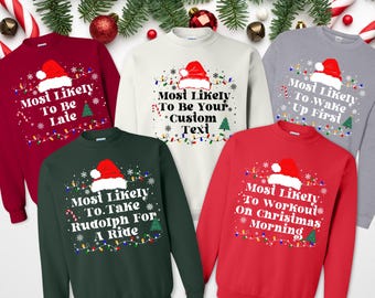 May include: Five Christmas sweaters with different sayings. The sweaters are red, green, white, and gray. The sayings on the sweaters are "Most Likely To Be Late", "Most Likely To Be Your Custom Text", "Most Likely To Take Rudolph For A Ride", "Most Likely To Wake Up First", and "Most Likely To Workout On Christmas Morning".