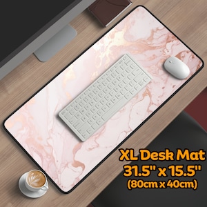 May include: A large pink and gold marble desk mat with a white keyboard and mouse on top. The mat is 31.5 inches by 15.5 inches (80cm x 40cm).