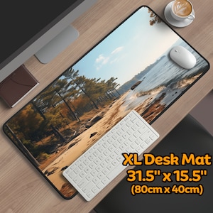 May include: A large desk mat with a scenic image of a forest and a beach. The mat is 31.5 inches by 15.5 inches (80cm x 40cm).