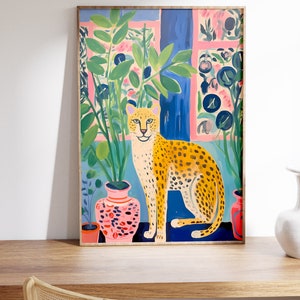 Discover our Cheetah Art Print, a retro-botanical gem featuring a Henri Matisse inspired touch. This trendy maximalist poster adds charm to your gallery wall, conjuring a lush jungle vibe with its tropical plants art print.