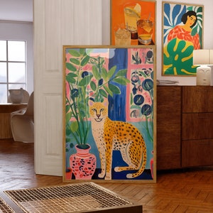 Discover our Cheetah Art Print, a retro-botanical gem featuring a Henri Matisse inspired touch. This trendy maximalist poster adds charm to your gallery wall, conjuring a lush jungle vibe with its tropical plants art print.