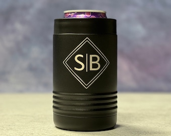 May include: Black insulated can cooler with a diamond-shaped design and the initials "S|B" engraved in silver.