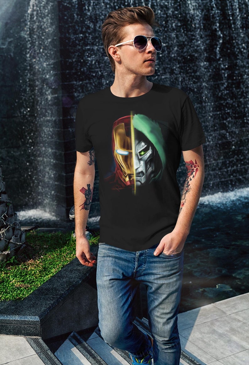 May include: A black t-shirt with a graphic print of Iron Man and Doctor Doom's faces split down the middle. The graphic is in red, yellow, green, and silver.