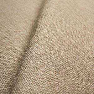 May include: Close-up of a beige fabric with a textured, woven pattern. The fabric has a subtle sheen and a soft appearance. The weave creates a grid-like design, adding visual interest to the textile.