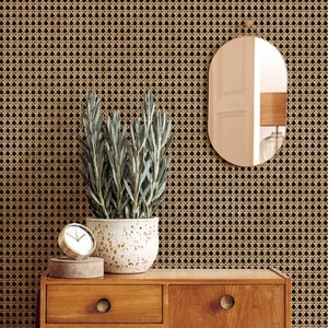 May include: A wooden dresser with two drawers, a decorative mirror, and a potted plant. The mirror has a gold frame and an oval shape. The plant is in a speckled white pot. A small gold clock sits on a wooden surface.