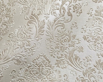 May include: A white background with a raised, embossed, gold-colored floral pattern.