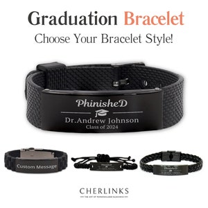 May include: Three black graduation bracelets with different styles. The top bracelet is a black silicone band with a black metal plate engraved with "PhinisheD", a graduation cap, "Dr. Andrew Johnson", and "Class of 2024". The middle bracelet is a black silicone band with a silver metal plate engraved with "Custom Message". The bottom bracelet is a black leather band with a black metal plate engraved with "PhinisheD", a graduation cap, "Dr. Andrew Johnson", and "Class of 2024".