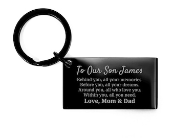 May include: Black rectangular keychain with a black ring. The keychain has the text "To Our Son James" and a message from "Love, Mom & Dad". The message includes the phrases "memories", "dreams", and "love you".
