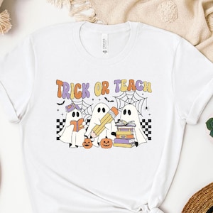 a white t - shirt with a trick or treat design on it