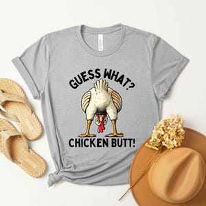 a t - shirt that says guess what chicken butt