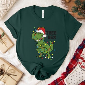 a t - shirt with a dinosaur wearing a christmas hat