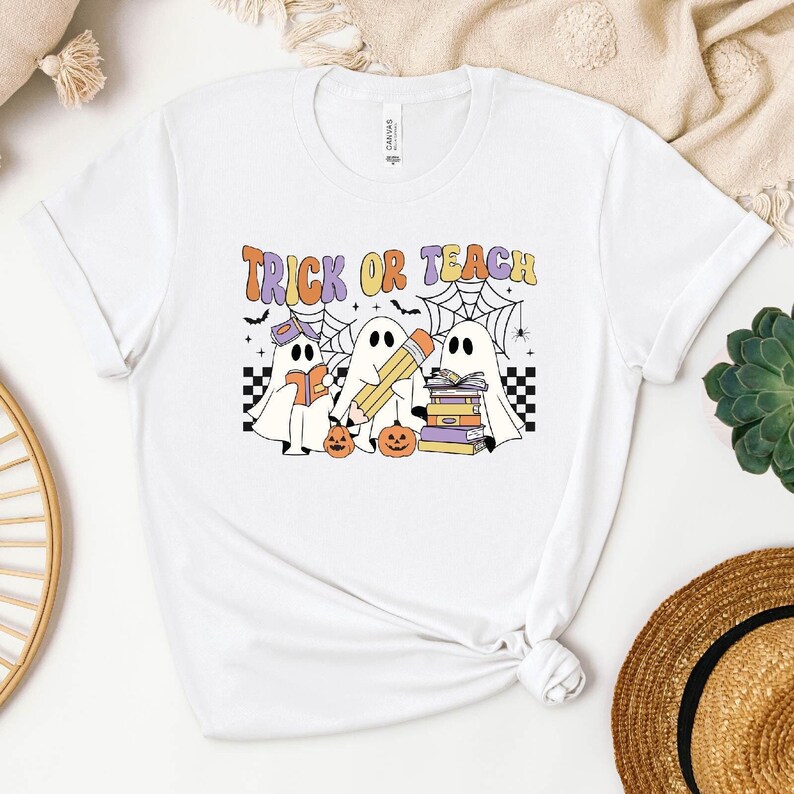 a white t - shirt with a trick or treat design on it