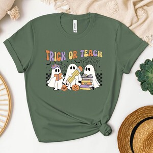 a t - shirt that says trick of teach with three ghostes