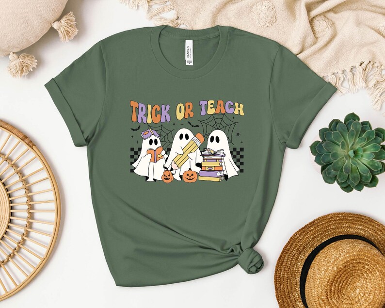 a t - shirt that says trick of teach with three ghostes