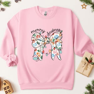 Sudadera con lazo &quot;Feliz Navidad&quot; de Coquette: Sudadera con capucha navideña