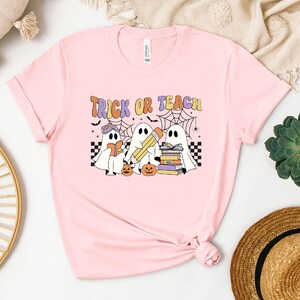 a pink t - shirt with trick or treat on it