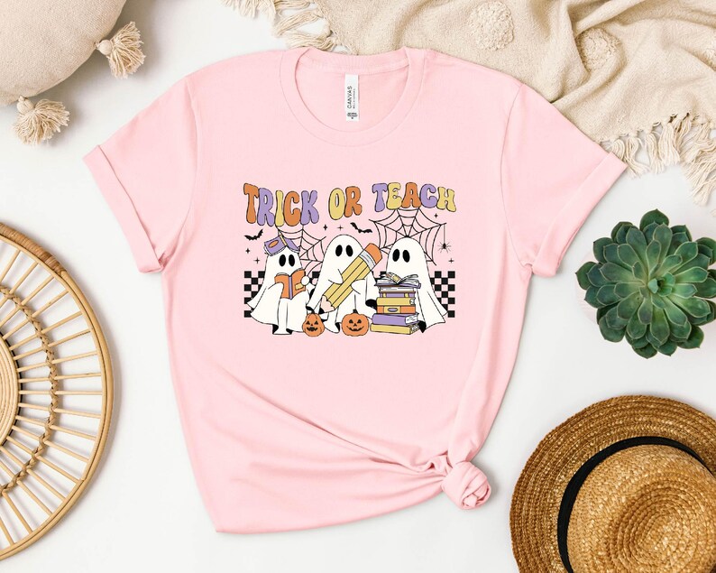 a pink t - shirt with trick or treat on it