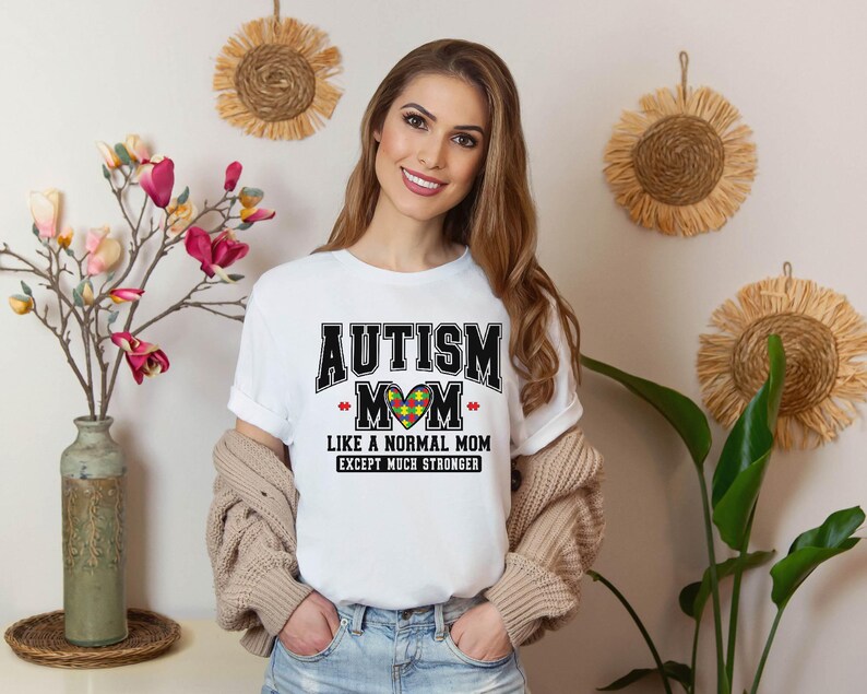a woman wearing a t - shirt that says autism mom