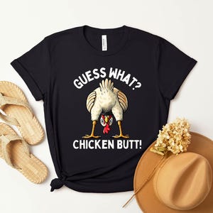 a t - shirt with a chicken saying guess what?