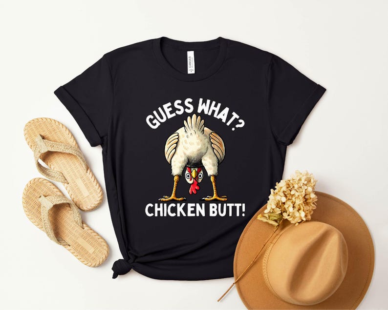 a t - shirt with a chicken saying guess what?