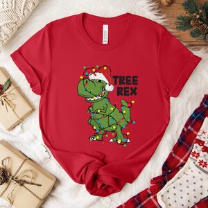 a t - shirt with a dinosaur wearing a santa hat