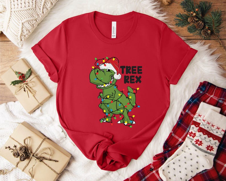 a t - shirt with a dinosaur wearing a santa hat