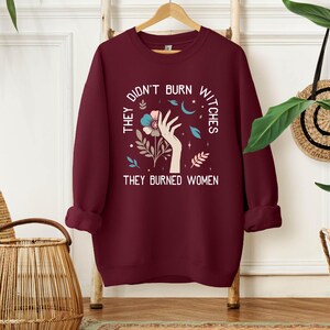 a red sweatshirt with the words, the don't burn why they burned women