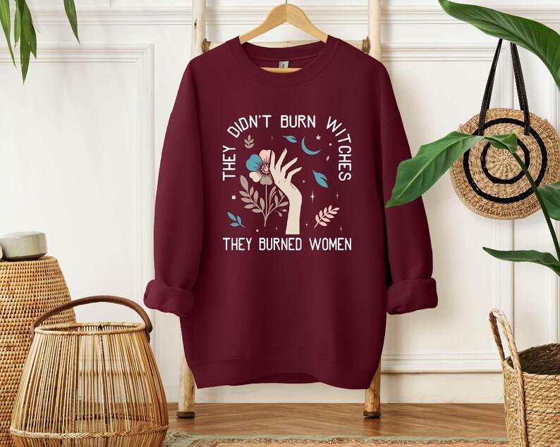 a red sweatshirt with the words, the don't burn why they burned women