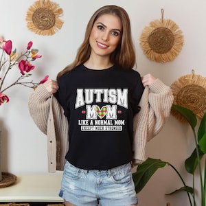 a woman wearing a t - shirt that says autism like a normal mom
