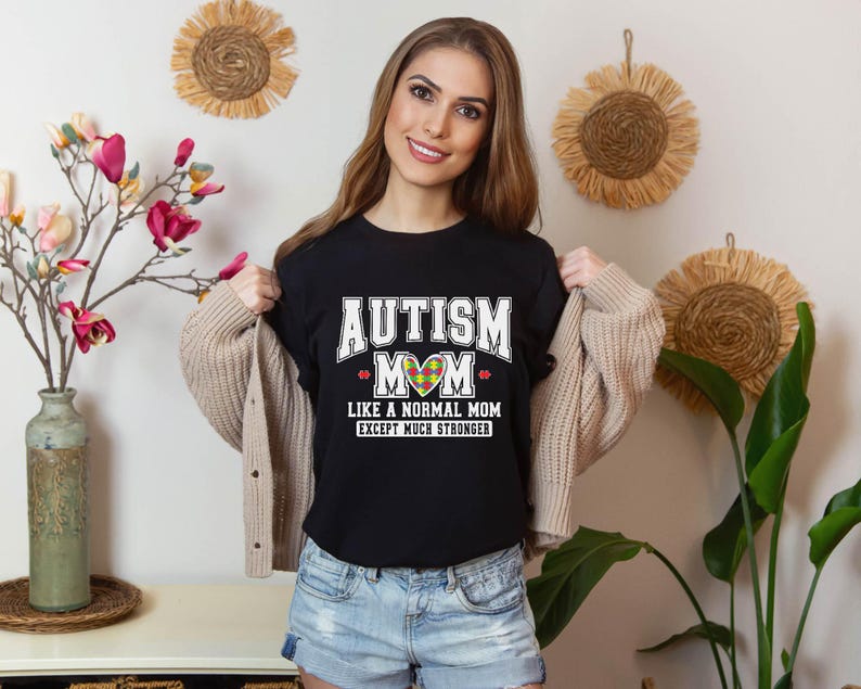 a woman wearing a t - shirt that says autism like a normal mom