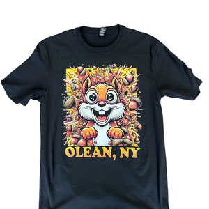 May include: Black t-shirt with a cartoon squirrel surrounded by acorns and the text "OLEAN, NY".