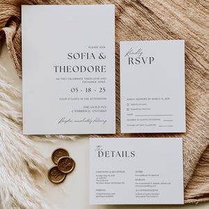 May include: A wedding invitation suite featuring a main invitation, RSVP card, and details card. The invitations are white with black text, including the names "Sofia & Theodore" and event details. Gold wax seals are also present.