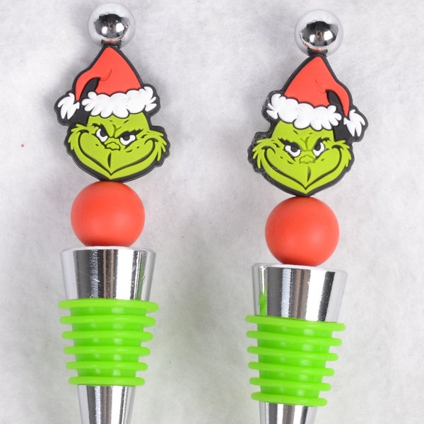 This lot of (2) Festive Holiday GRINCH Silicone Wine Bottle Stoppers 4.5"L