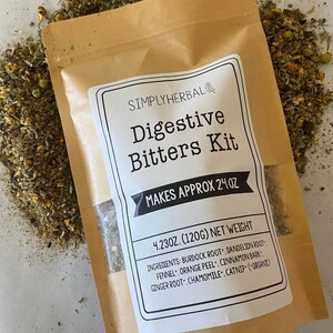 May include: A brown paper bag with a white label that reads "SIMPLYHERBAL Digestive Bitters Kit MAKES APPROX 24 OZ 4.23OZ. (120G) NET WEIGHT INGREDIENTS: BURDOCK ROOT, DANDELION ROOT FENNEL, ORANGE PEEL, CINNAMON BARK GINGER ROOT, CHAMOMILE. CATNIP- (ORGANIC)"