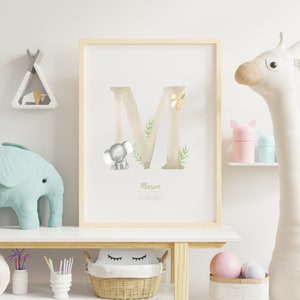 May include: A watercolour print featuring a large letter M with a small elephant and floral accents. The name Mason Clifford is written below the letter.